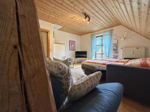 a living room with two beds and a couch at Weiherblasch II in Dietersdorf