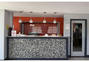 a kitchen with orange walls and a counter top at Conn Brown Harbour Inn Aransas Pass Corpus Christi in Aransas Pass +20 photos