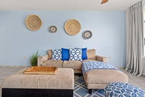 a living room with a couch and a table at Santorini Coastal Vibe Apartment in Costa Brava Ceiba in Santa Maria +27 photos