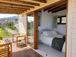 a bedroom with a bed on a wooden deck at El Cornical Luxury Bungalows in Arafo