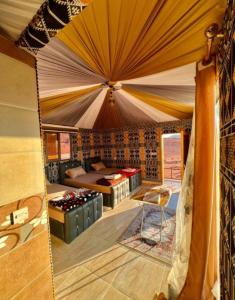 a room with a bed and a tent at RUM DREAM BUBBLES lUXURY CAMP in Wadi Rum