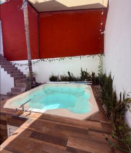 a jacuzzi tub in a courtyard with a staircase at Sabalo's Hausen in Mazatlán