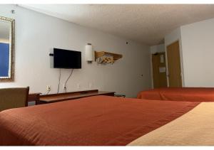 a hotel room with two beds and a flat screen tv at Conn Brown Harbour Inn Aransas Pass Corpus Christi in Aransas Pass
