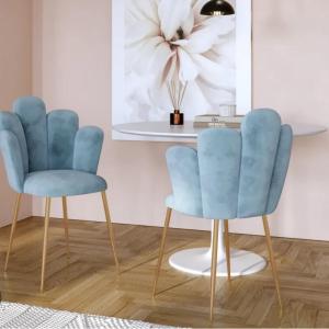 two blue chairs in a room with a table at ClaMar Apart Hotel in Porto Ercole