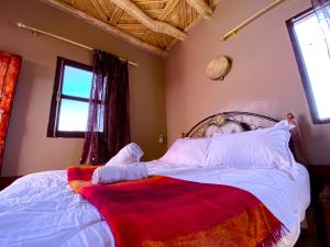 Ένα ή περισσότερα κρεβάτια σε δωμάτιο στο Gite d'étape Asfalou chez l'habitant