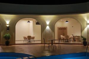 a room with a table and chairs and a dining room at Serene Kabini Wild lodge in Kabini River