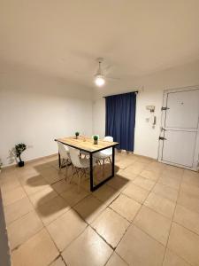 a room with a table and two chairs in it at Alojamiento En Resistencia Chaco in Resistencia