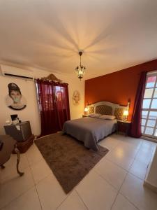 a bedroom with a bed and a chandelier at Sabalo's Hausen in Mazatlán +66 photos