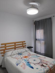 a bedroom with a large bed with a flower blanket at Ca L'Esparter in Bocairent