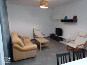 a living room with two chairs and a tv at Ca L'Esparter in Bocairent