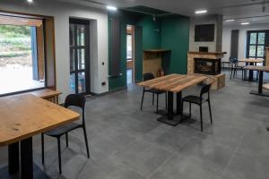 a room with tables and chairs and a fireplace at Bilyi Slon Gadzhyna in Bystshets