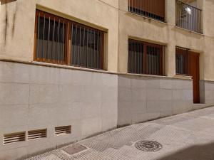 a building with windows and a sidewalk in front of it at Ca L'Esparter in Bocairent +15 photos