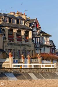 a large house sitting on top of a bridge at La Vigie - Maison en bord de mer in Lion-sur-Mer