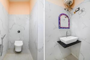 a white bathroom with a sink and a toilet at Hotel O Nilkanth Nivas in Puri