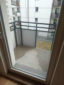 an open window with a view of a balcony at Old Town Apartment Elbląg in Elblag