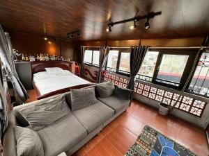 a living room with a couch and a bed at Ubuntu Sky view 139 Hang Bac in Hanoi