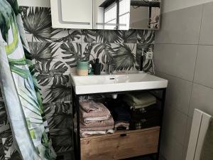 a bathroom with a sink and a shower curtain at Gästezimmer 21qm im Casa Kirchweg in Gladbach