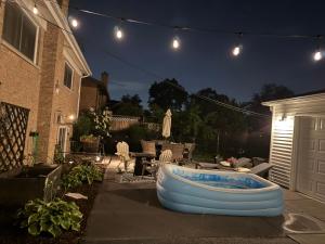 a backyard with a tub in the yard at night at Chester Casa in Niles