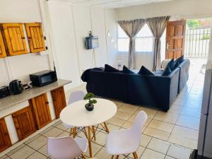a living room with a couch and a table and chairs at ZM Rooted Properties in Frankfort