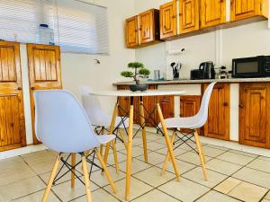 a kitchen with wooden cabinets and a table and chairs at ZM Rooted Properties in Frankfort +15 photos