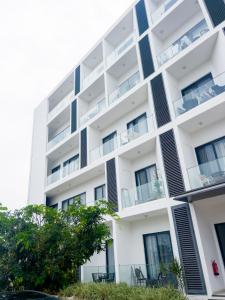 an apartment building with balconies and trees at Luxury Studio Apt at 233 Boulevard Cantonment-Accra in Accra +18 photos