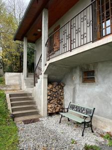 a bench sitting in front of a house with a staircase at Gîte 6 personnes Chez Gaby in Montgreleix +11 photos