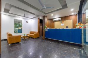an office lobby with a blue counter and chairs at Hotel Aura Grand sector 63A Noida I Couple Friendly in Noida +71 photos