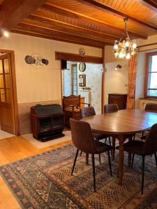 a dining room with a table and a stove at Gîte 6 personnes Chez Gaby in Montgreleix