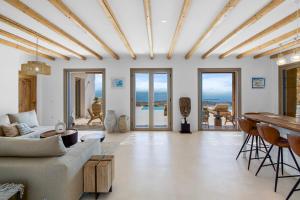 a living room with a couch and a table at Villa Lazuli - Golden Beach in Márpissa