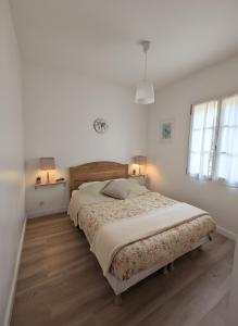 a bedroom with a large bed with two lamps on the wall at Domaine de Fayence in Fayence +49 photos