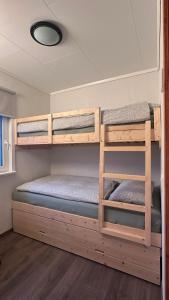 Zimmer mit 2 Etagenbetten in einem Wohnwagen in der Unterkunft Det gule huset - Nordic Horn in Brostadbotn