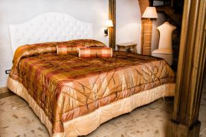 a bedroom with a bed with a comforter on it at B&B Casa Dilillo in Foggia