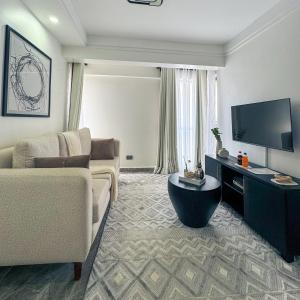 a living room with a couch and a flat screen tv at Getaways homes in Nairobi