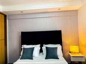 a bedroom with a large bed with a striped wall at Getaways homes in Nairobi