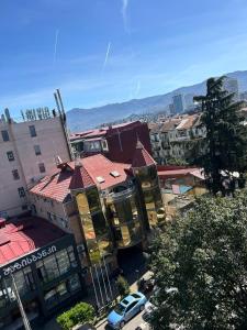 a group of buildings in a city with a car at Your home in the heart of Batumi, sea in 8th minute in Batumi