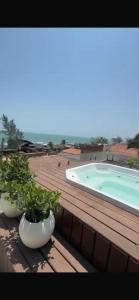 twootted plants on a deck with a swimming pool at Pousada Vista Encantada Preá in Cruz