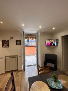 a living room with a chair and a television on the wall at Casa Cristina2 in Grottaferrata