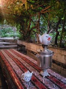 two tea pots sitting on top of a table at Village house Palma in Mingachevir