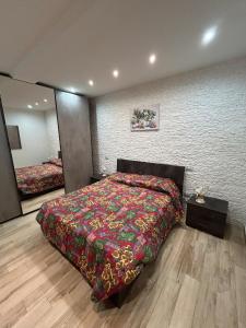 a bedroom with a large bed and a mirror at Casa Cristina2 in Grottaferrata +21 photos