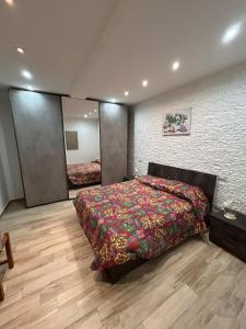 a bedroom with a bed and a brick wall at Casa Cristina2 in Grottaferrata