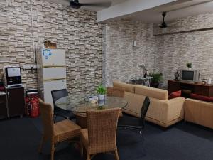 a living room with a table and a couch at Vintage Inn Jonker Walk Melaka in Melaka