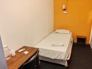 a small room with a bed and a table at Vintage Inn Jonker Walk Melaka in Melaka +47 photos