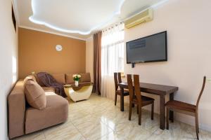 a living room with a couch and a table at 1 bedroom Modern, Sunny apartment in Amiryan street AM104 in Yerevan