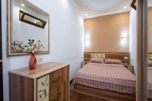 a small bedroom with a bed and a mirror at 1 bedroom Modern, Sunny apartment in Amiryan street AM104 in Yerevan