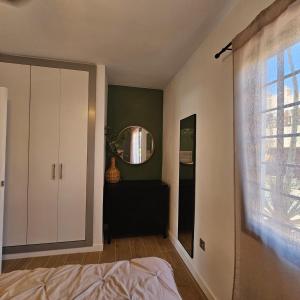 a bedroom with a white cabinet and a mirror at Duna Lagoon in Corralejo +12 photos