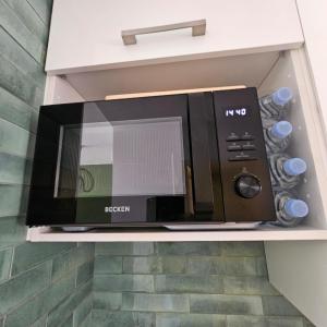 a microwave oven sitting on a shelf in a kitchen at Duna Lagoon in Corralejo