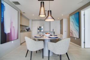 a kitchen and dining room with a table and chairs at Upscale Condo w/ Pool Access in Hyde Beach House! in Hollywood