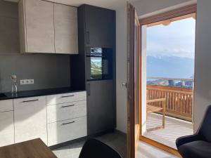 a kitchen with a view of a balcony at Brixlechnerhof in Maranza