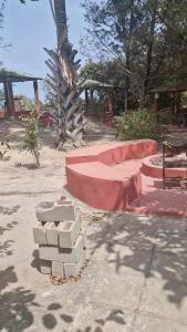 a pile of bricks and a bench in a park at Tanji Bco Bird Resort in Tanji