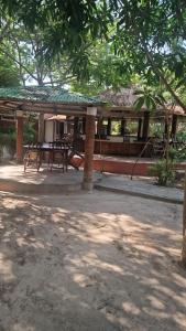 a pavilion with a picnic table in a park at Tanji Bco Bird Resort in Tanji